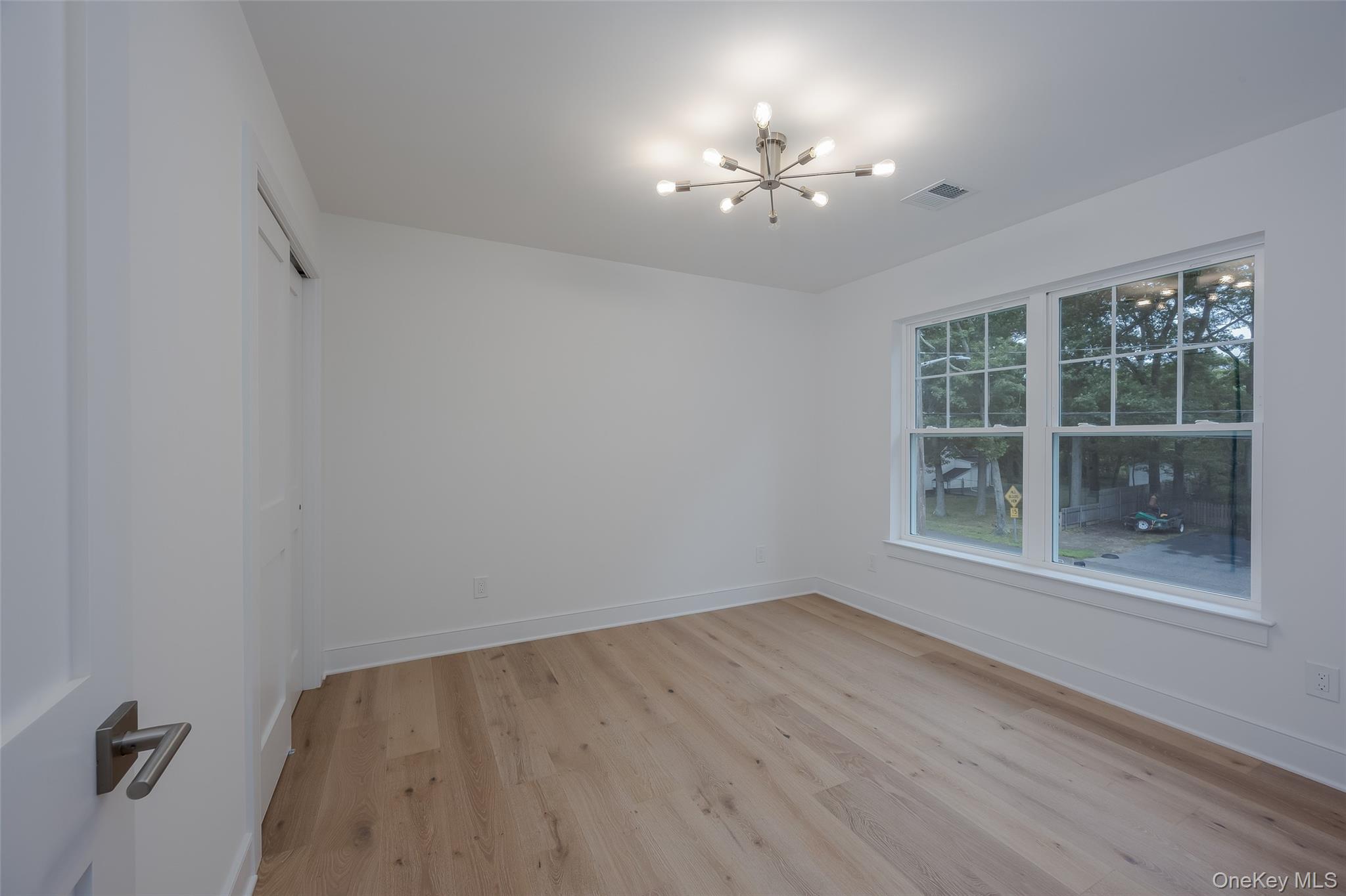 40 Zenith Road Rocky Point, NY 11778 - Photo 31 of 38 wooden floor in an empty room with a window
