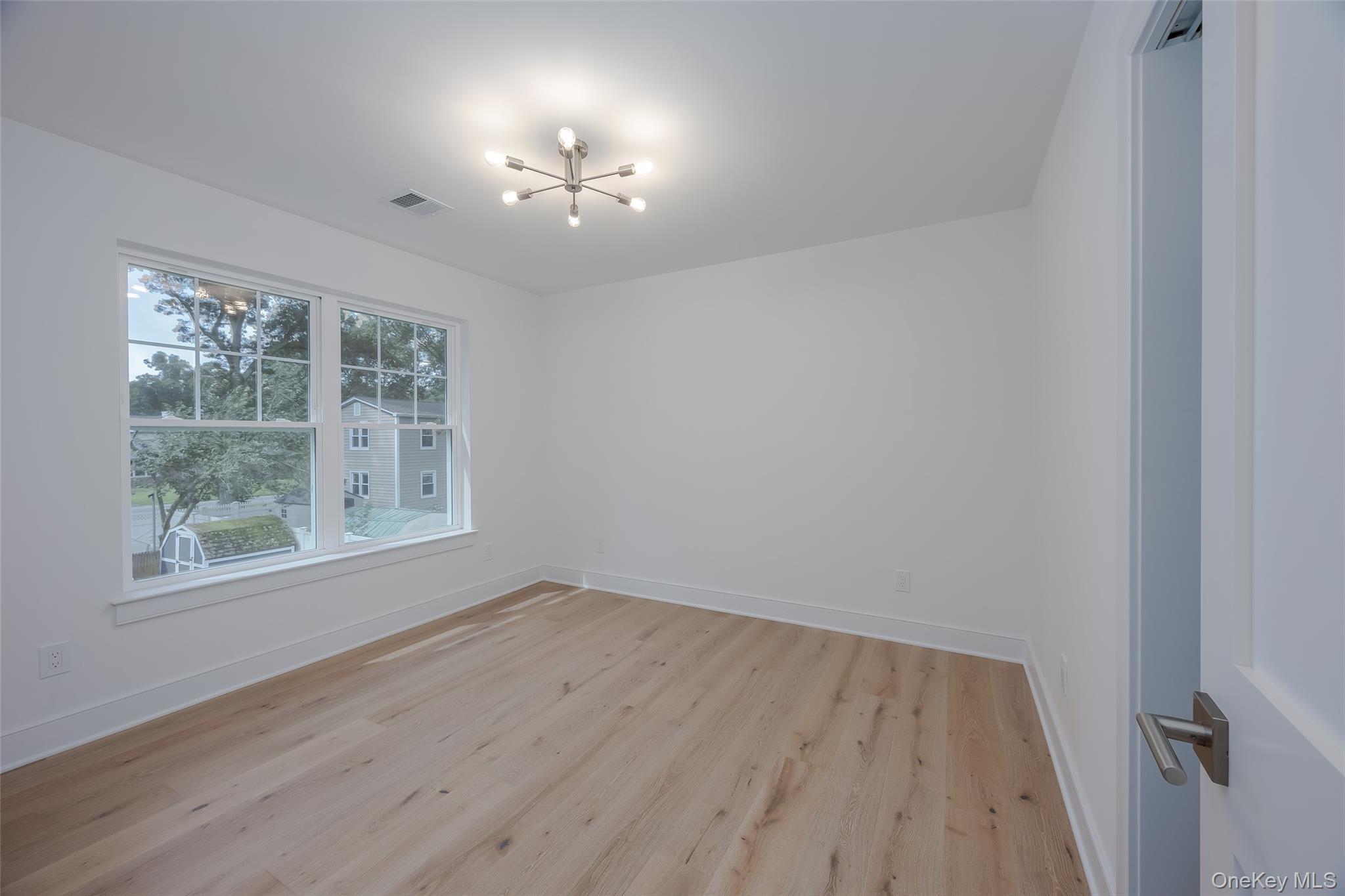 40 Zenith Road Rocky Point, NY 11778 - Photo 32 of 38 a view of an empty room with wooden floor and a window