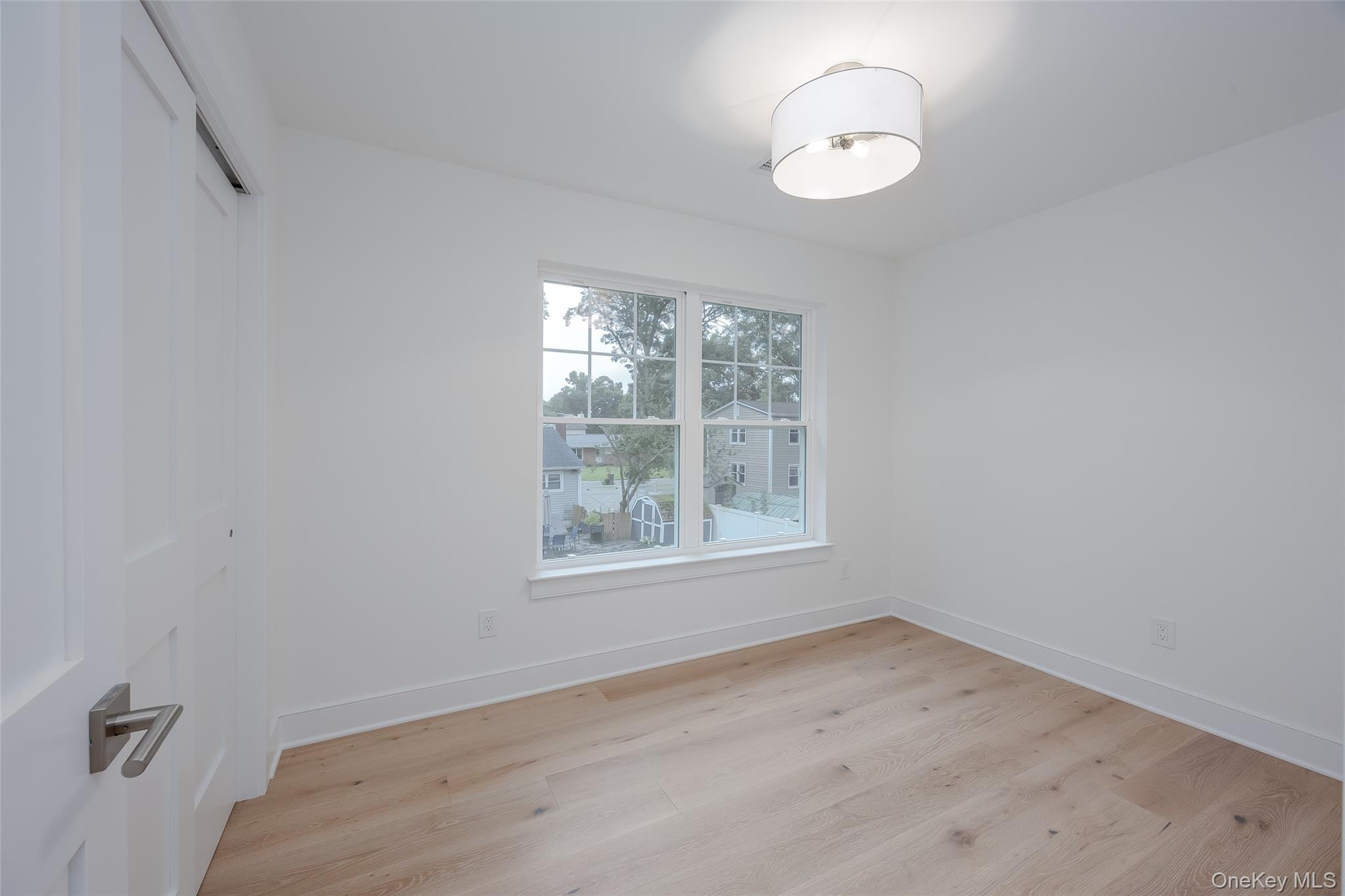 40 Zenith Road Rocky Point, NY 11778 - Photo 33 of 38 an empty room with wooden floor and windows