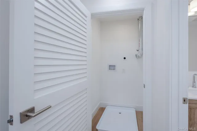 a view of a room with wooden floor