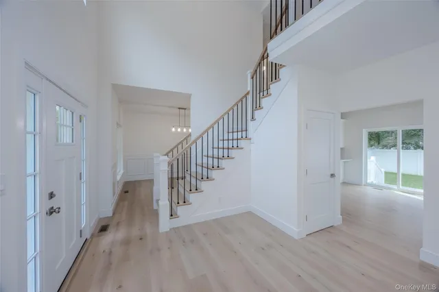 a view of entryway and hall with wooden floor