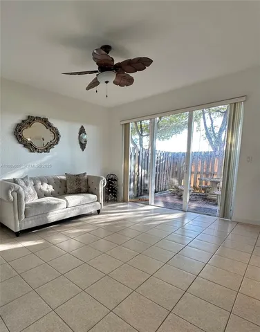 a living room with furniture and a floor to ceiling window
