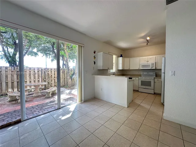 a kitchen with a stove a sink and a refrigerator