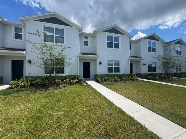 a front view of a house with a yard