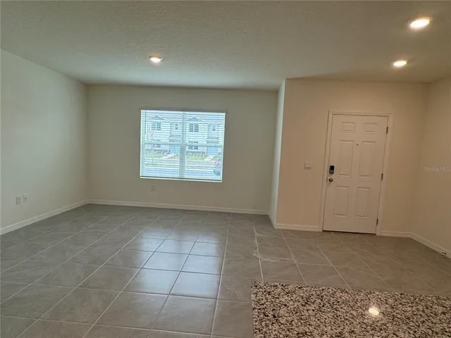 a kitchen with stainless steel appliances granite countertop a refrigerator a stove and a sink