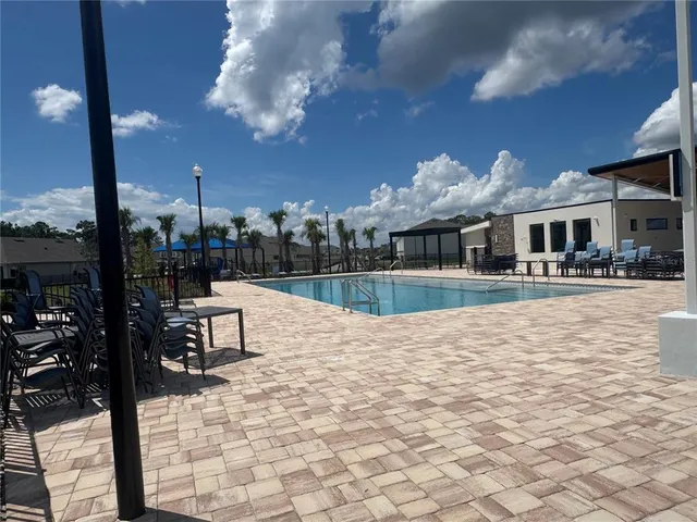 a view of pool with brick walls