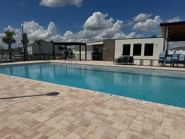 a view of a house with swimming pool and porch