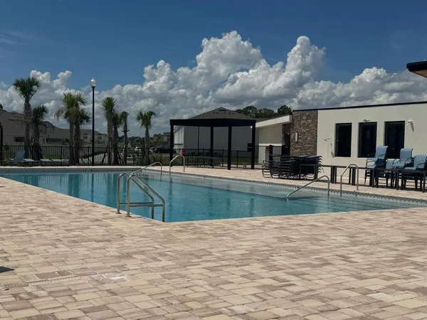 a view of pool with brick walls
