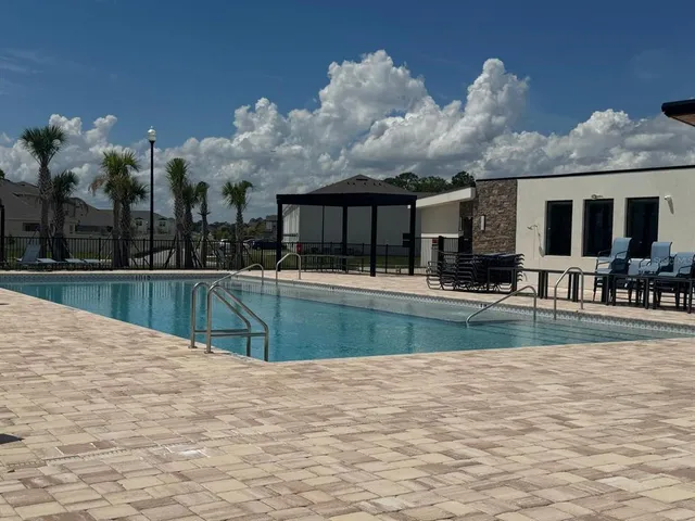 a view of pool with brick walls