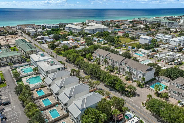 a view of swimming pool with outdoor seating and wooden fence