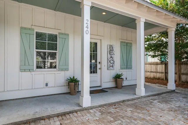 a view of a house with backyard porch and sitting area