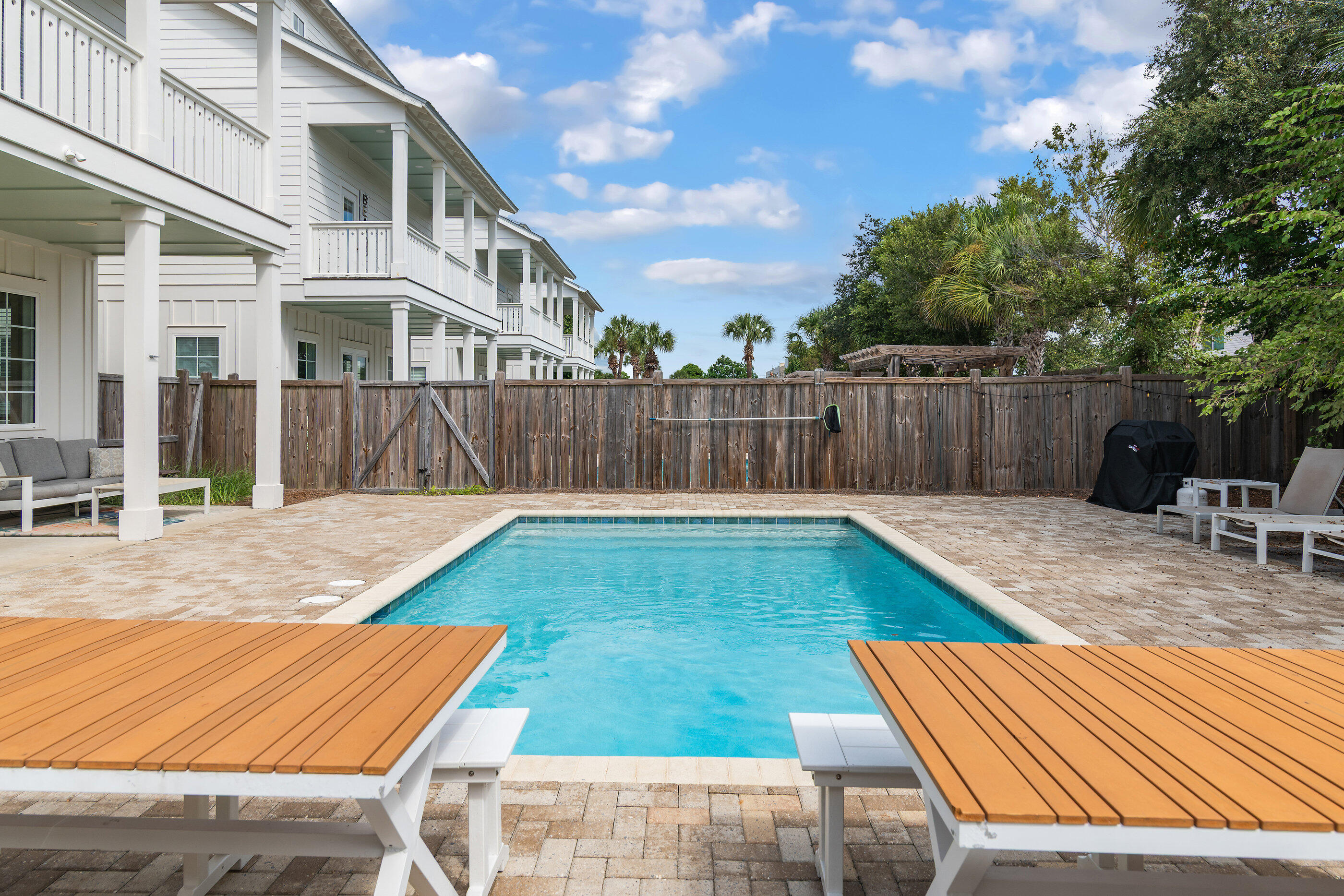 240 Driftwood Road Miramar Beach, FL 32550 - Photo 15 of 65 a view of swimming pool with outdoor seating and wooden fence
