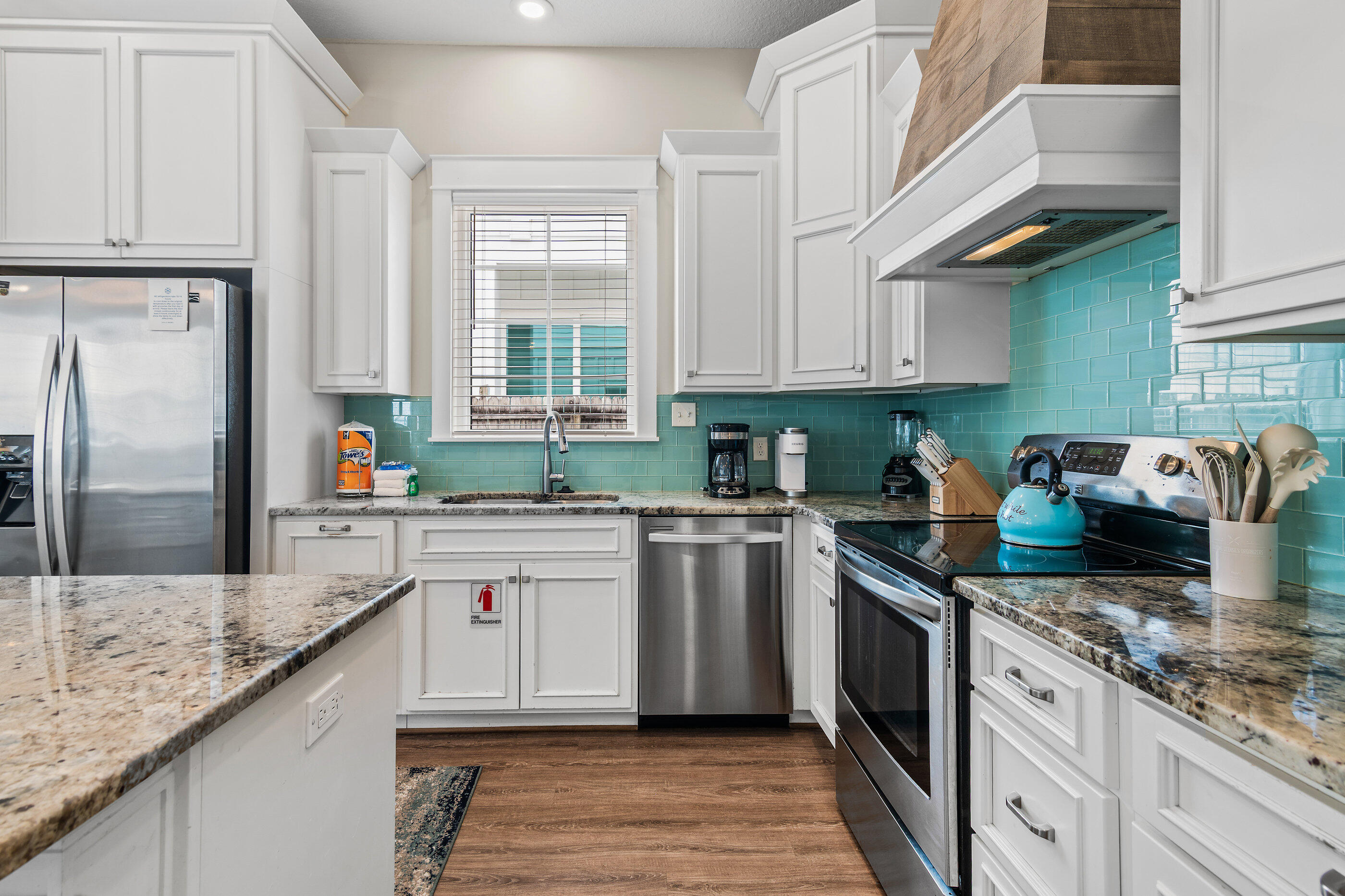 240 Driftwood Road Miramar Beach, FL 32550 - Photo 32 of 65 a kitchen with stainless steel appliances granite countertop a sink stove and refrigerator