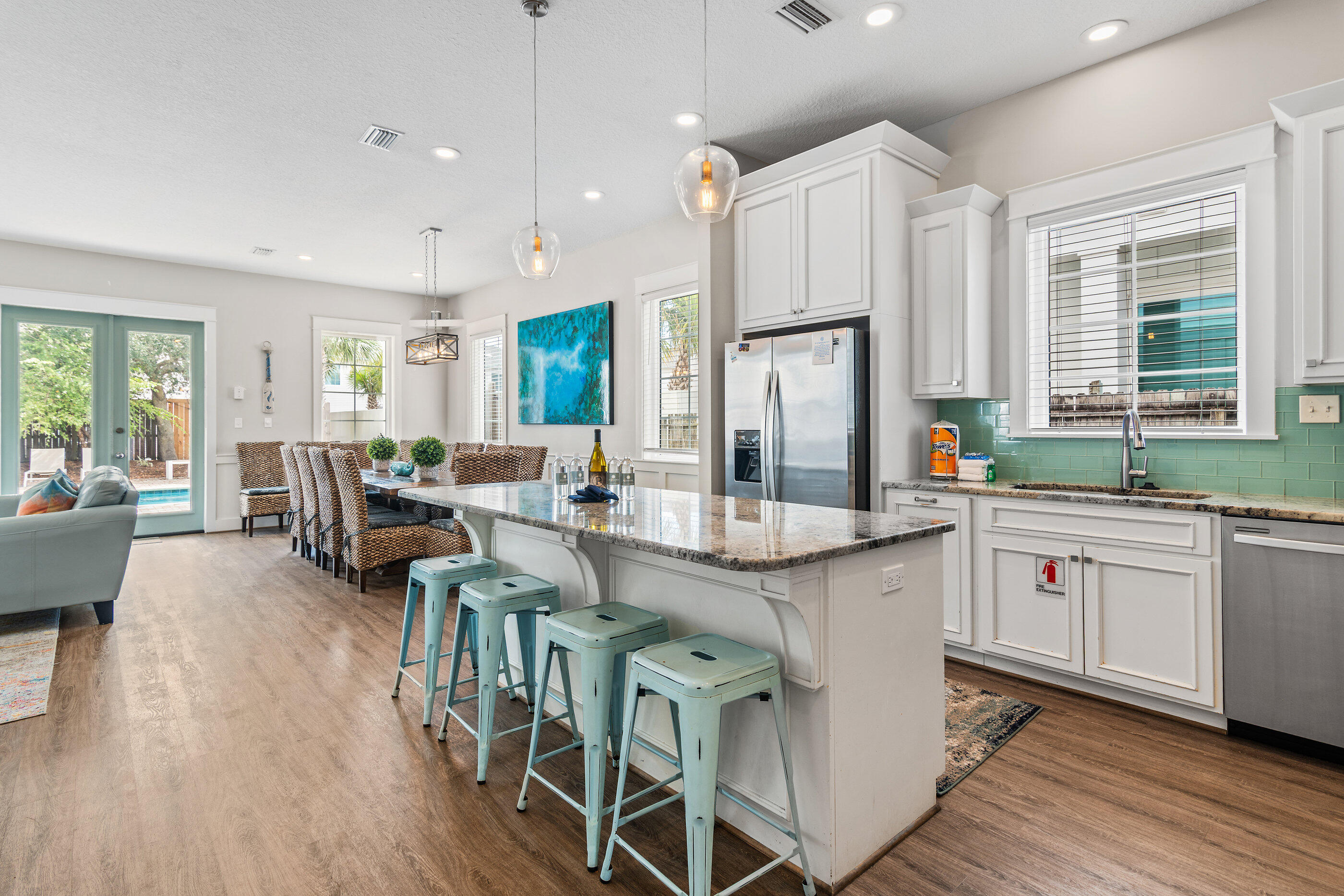 240 Driftwood Road Miramar Beach, FL 32550 - Photo 33 of 65 a large kitchen with lots of counter space dining table and stainless steel appliances