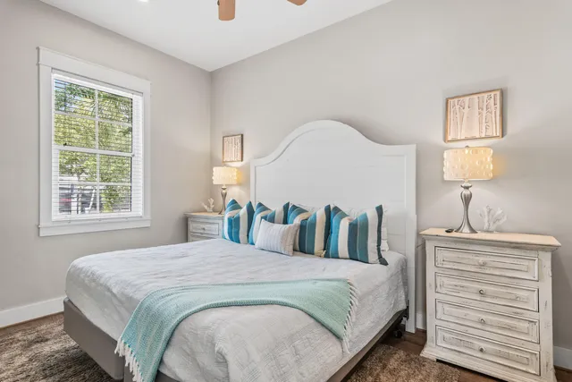 a bedroom with a large bed and a lamp