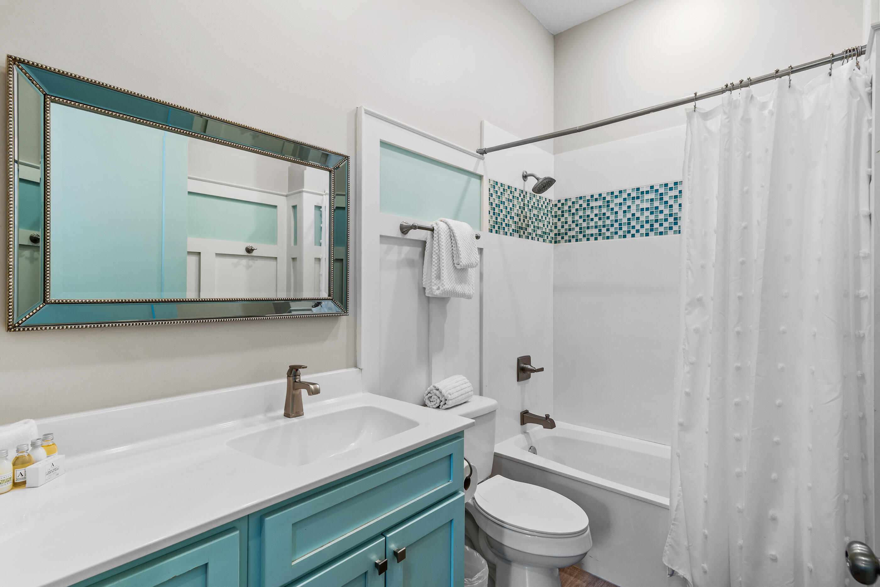 240 Driftwood Road Miramar Beach, FL 32550 - Photo 37 of 65 a bathroom with a granite countertop sink a toilet a mirror and shower