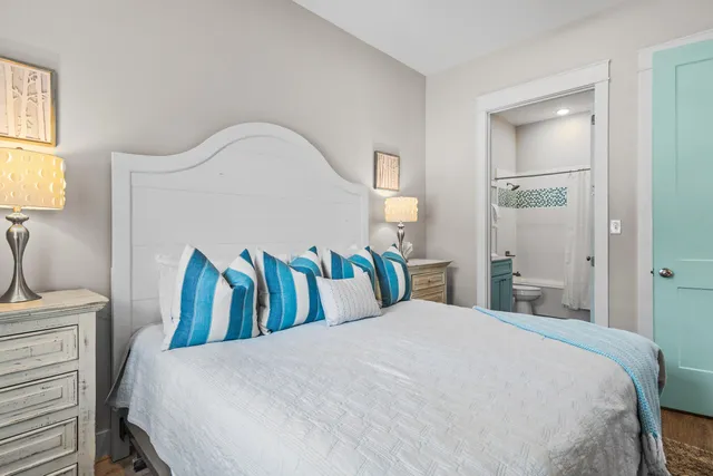 a bedroom with a bed and a lamp on table