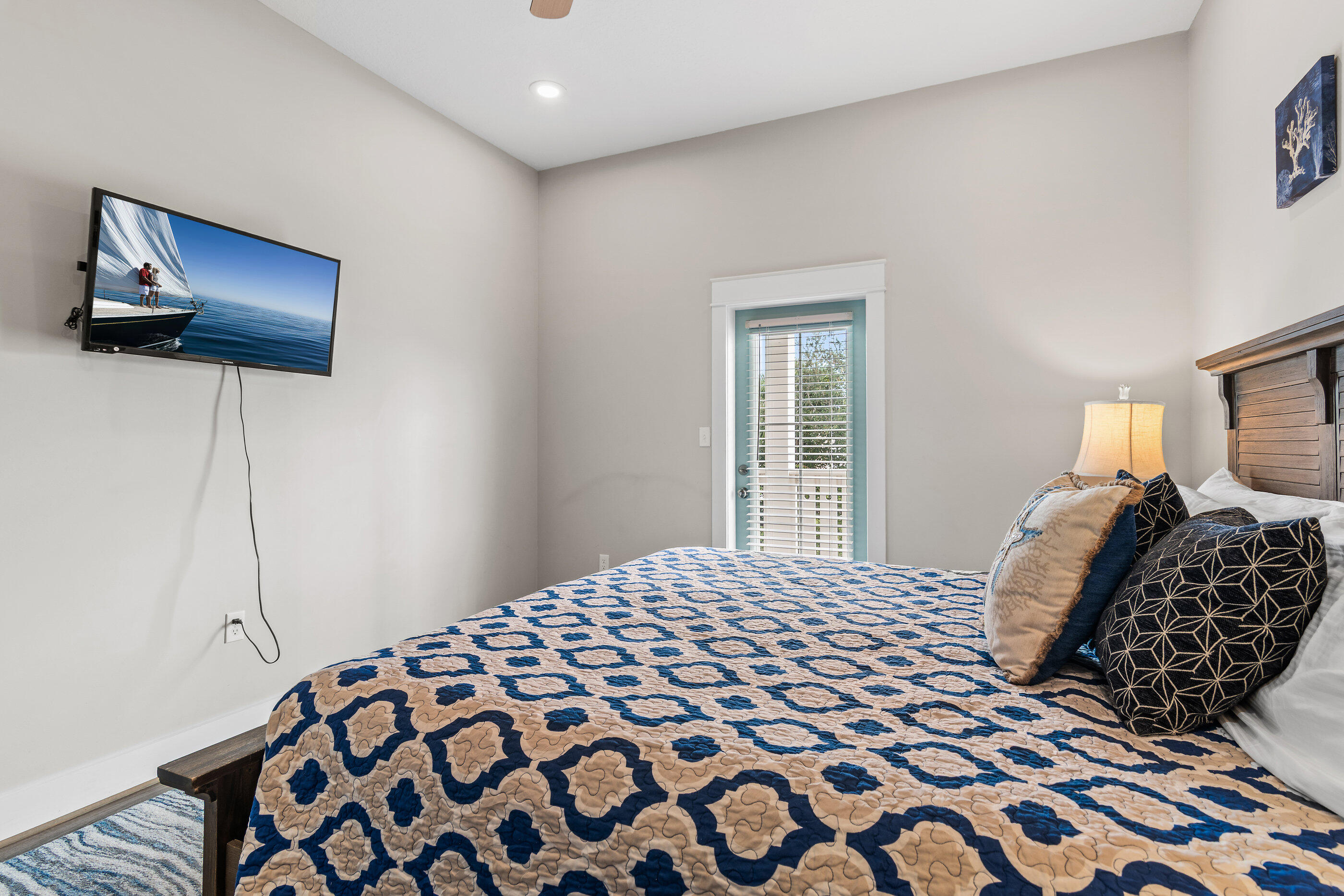 240 Driftwood Road Miramar Beach, FL 32550 - Photo 43 of 65 a bedroom with a bed and a lamp on dresser