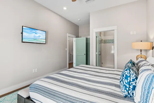 a bedroom with furniture and a flat screen tv