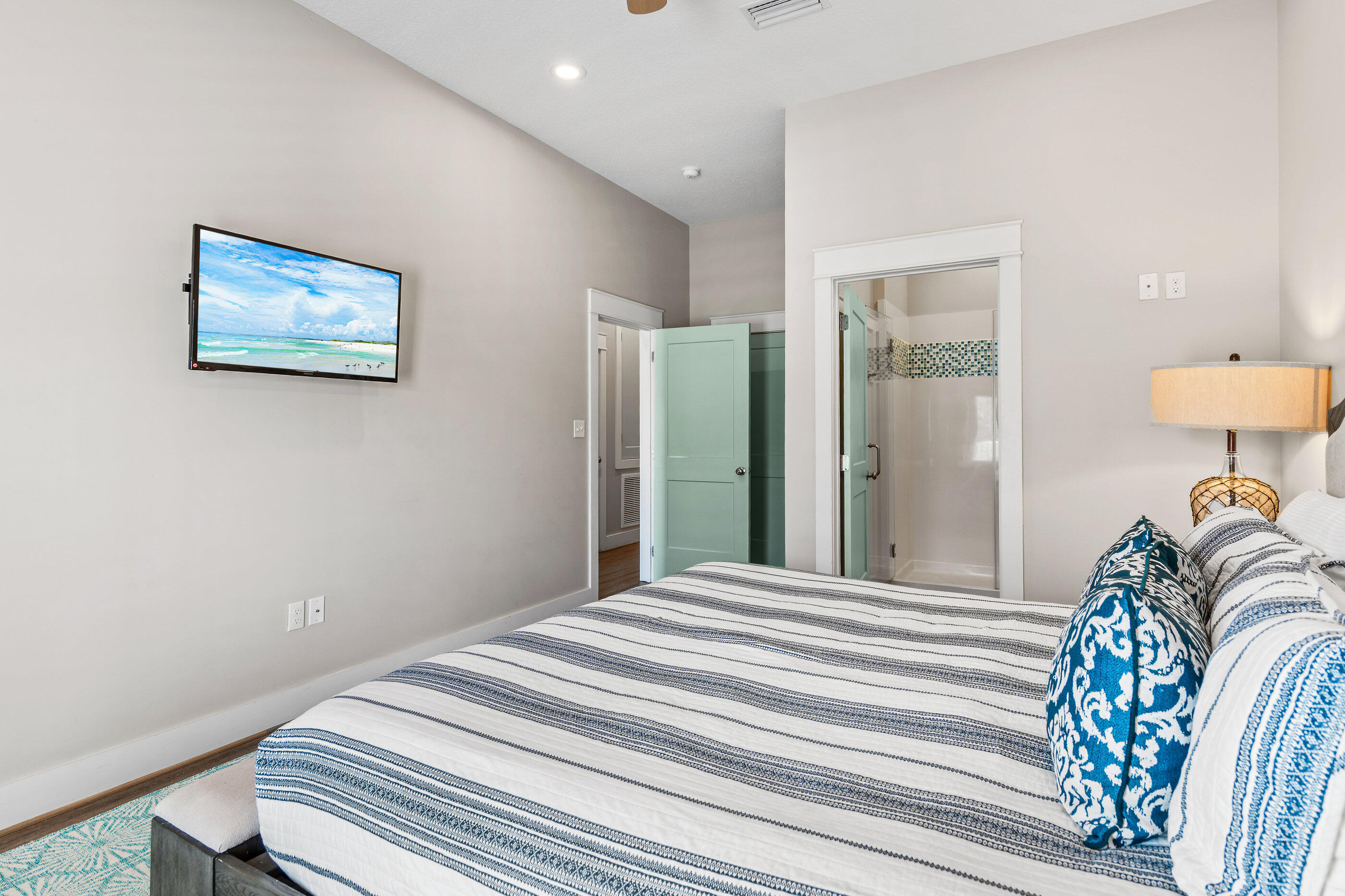 240 Driftwood Road Miramar Beach, FL 32550 - Photo 48 of 65 a bedroom with a bed and a lamp on table