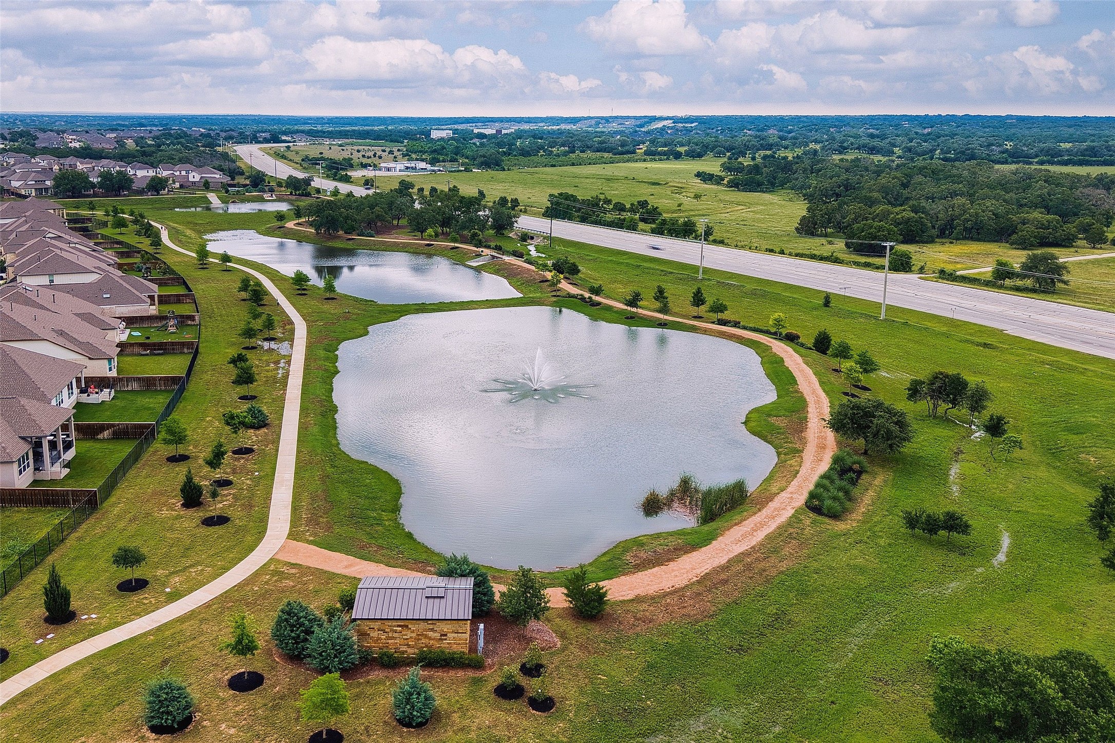 2408 Nate's Place Georgetown, TX 78633 - Photo 37 of 40 A tranquil pond with a fountain offers scenic views from this well-maintained community.