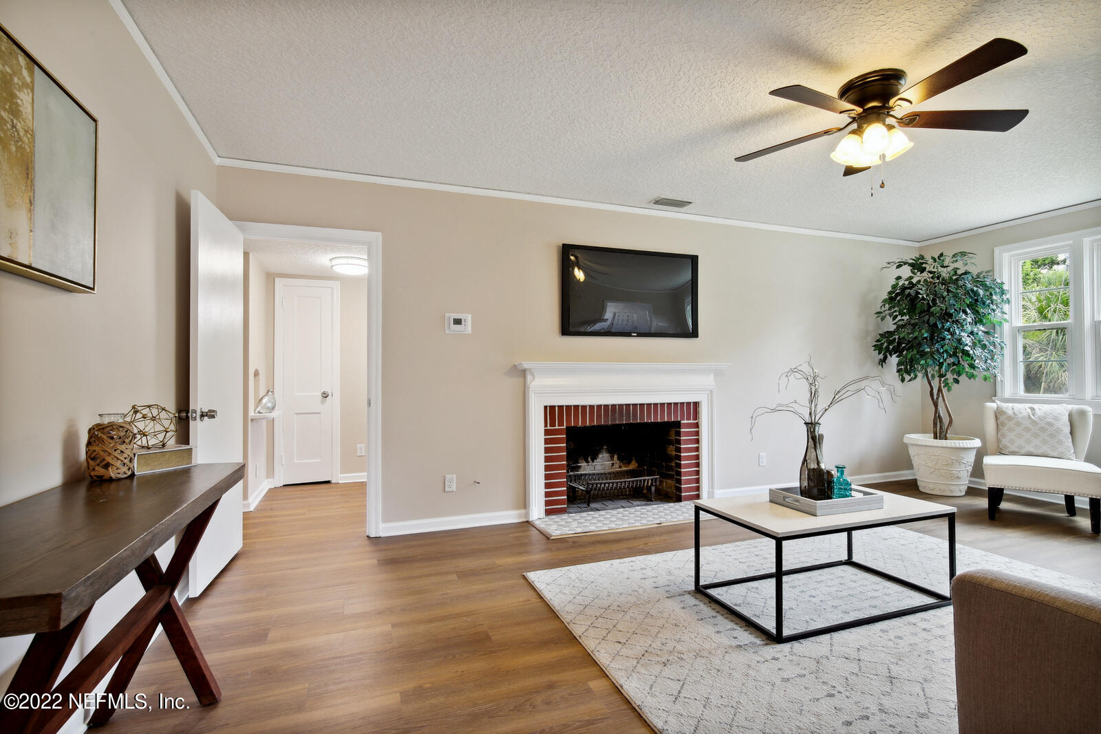 1639 Mayfair Road Jacksonville, FL 32207 - Photo 8 of 26 a living room with furniture a fireplace and a flat screen tv