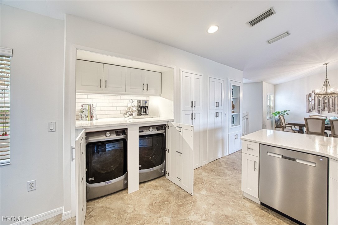 9570 Hemingway Lane, Unit 3205 Fort Myers, FL 33913 - Photo 12 of 43 a kitchen with stainless steel appliances a stove a sink and a refrigerator
