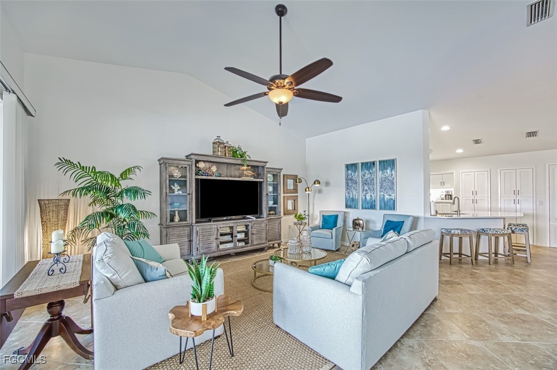 9570 Hemingway Lane, Unit 3205 Fort Myers, FL 33913 - Photo 16 of 43 a living room with furniture a ceiling fan and a flat screen tv