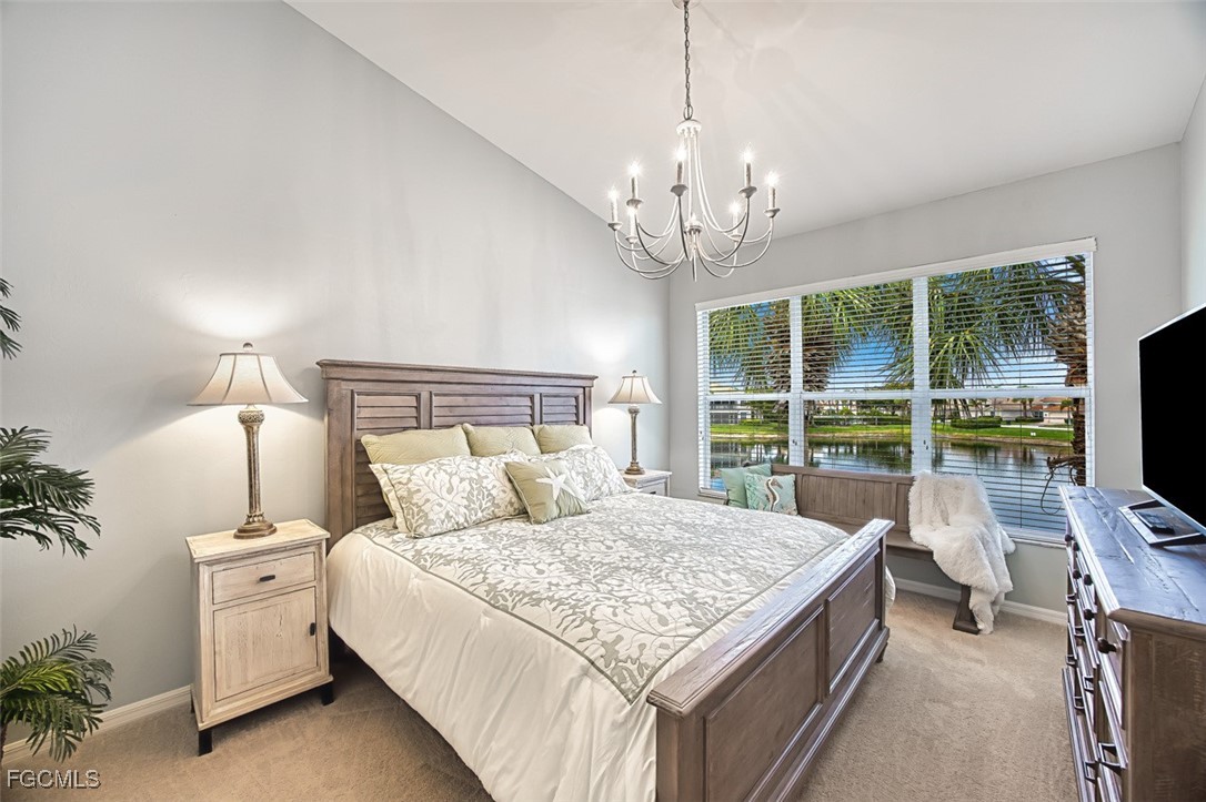9570 Hemingway Lane, Unit 3205 Fort Myers, FL 33913 - Photo 19 of 43 a bedroom with a large bed and a flat tv screen on a dresser