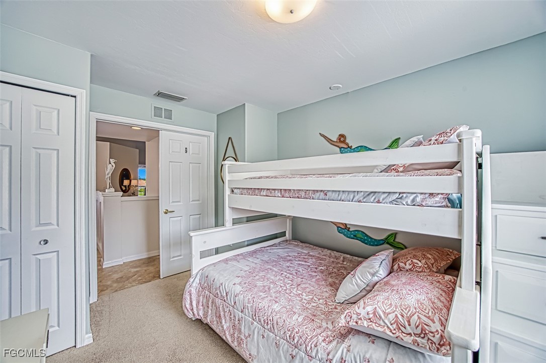 9570 Hemingway Lane, Unit 3205 Fort Myers, FL 33913 - Photo 24 of 43 a bedroom with a bed and a closet