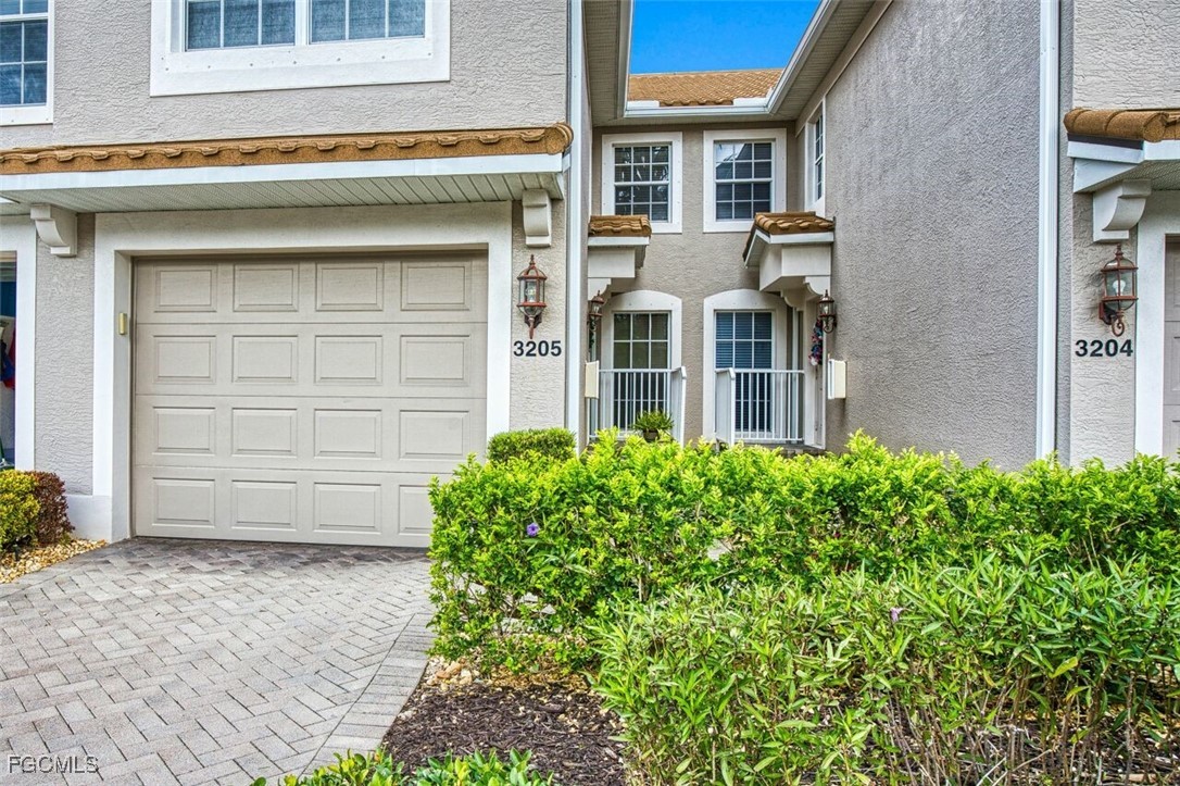 9570 Hemingway Lane, Unit 3205 Fort Myers, FL 33913 - Photo 5 of 43 a front view of a house with a garden