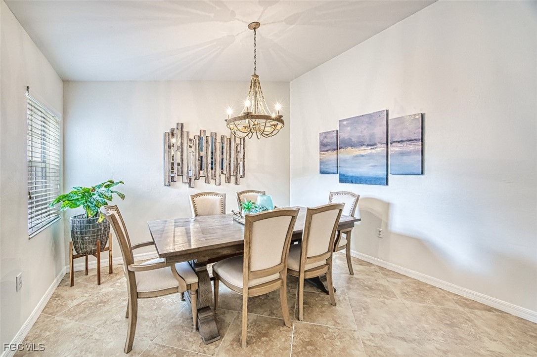 9570 Hemingway Lane, Unit 3205 Fort Myers, FL 33913 - Photo 8 of 43 a view of a dining room with furniture window and wooden floor