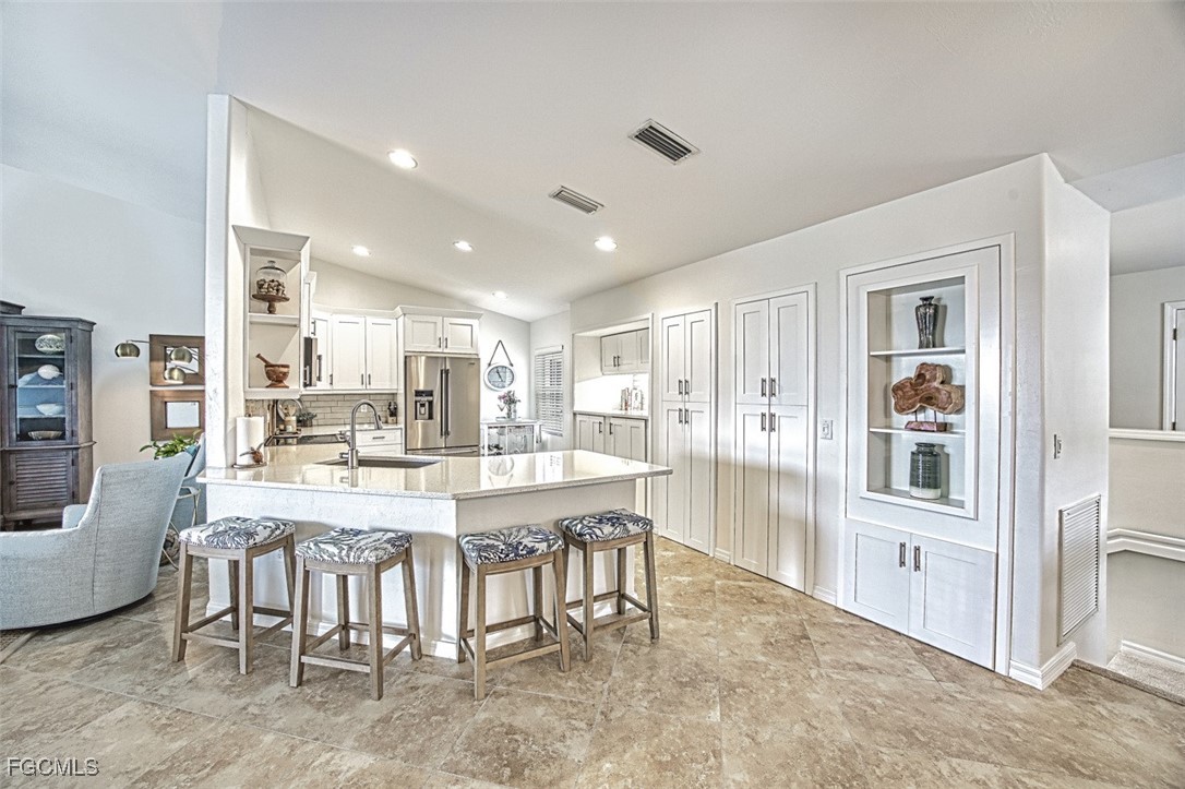 9570 Hemingway Lane, Unit 3205 Fort Myers, FL 33913 - Photo 10 of 43 a dining hall with stainless steel appliances granite countertop a stove and a dining table with kitchen view