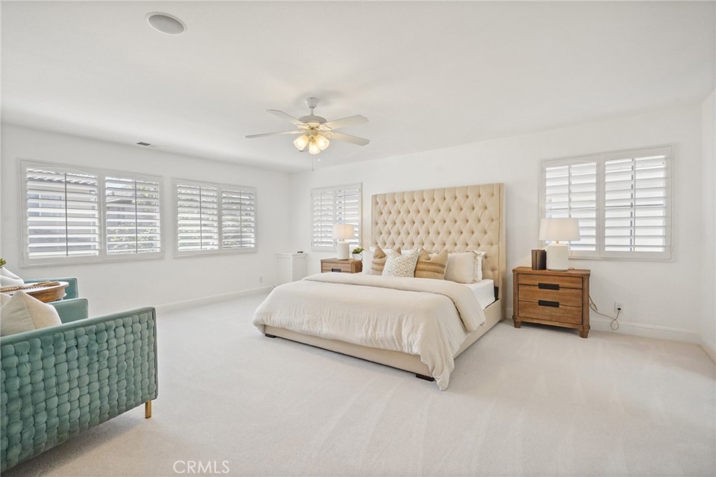 28 Rosenblum Irvine, CA 92602 - Photo 15 of 30 a spacious bedroom with a bed and a chandelier