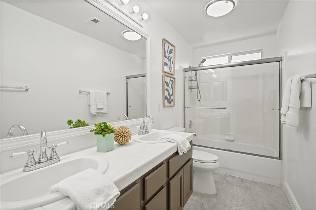 28 Rosenblum Irvine, CA 92602 - Photo 21 of 30 a bathroom with a granite countertop sink toilet and shower