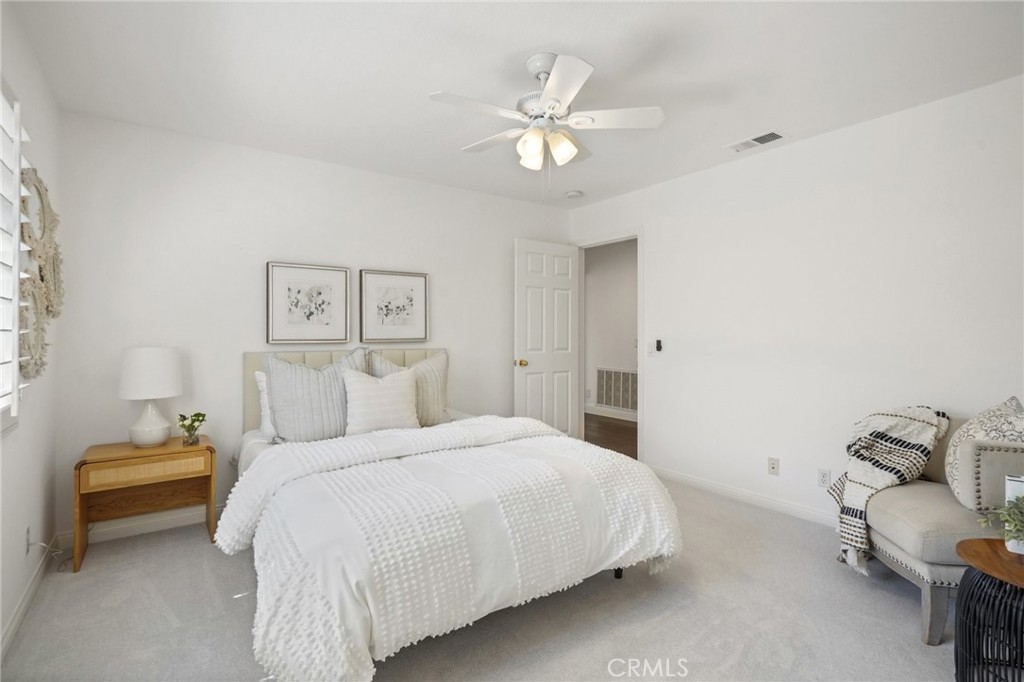 28 Rosenblum Irvine, CA 92602 - Photo 22 of 30 a bedroom with a bed and a chandelier