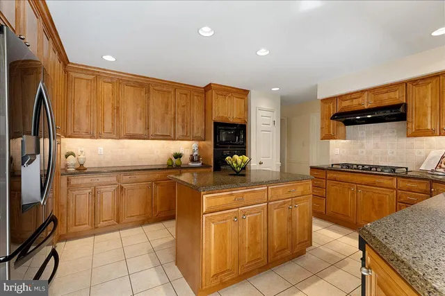 a kitchen with cabinets appliances and a counter space