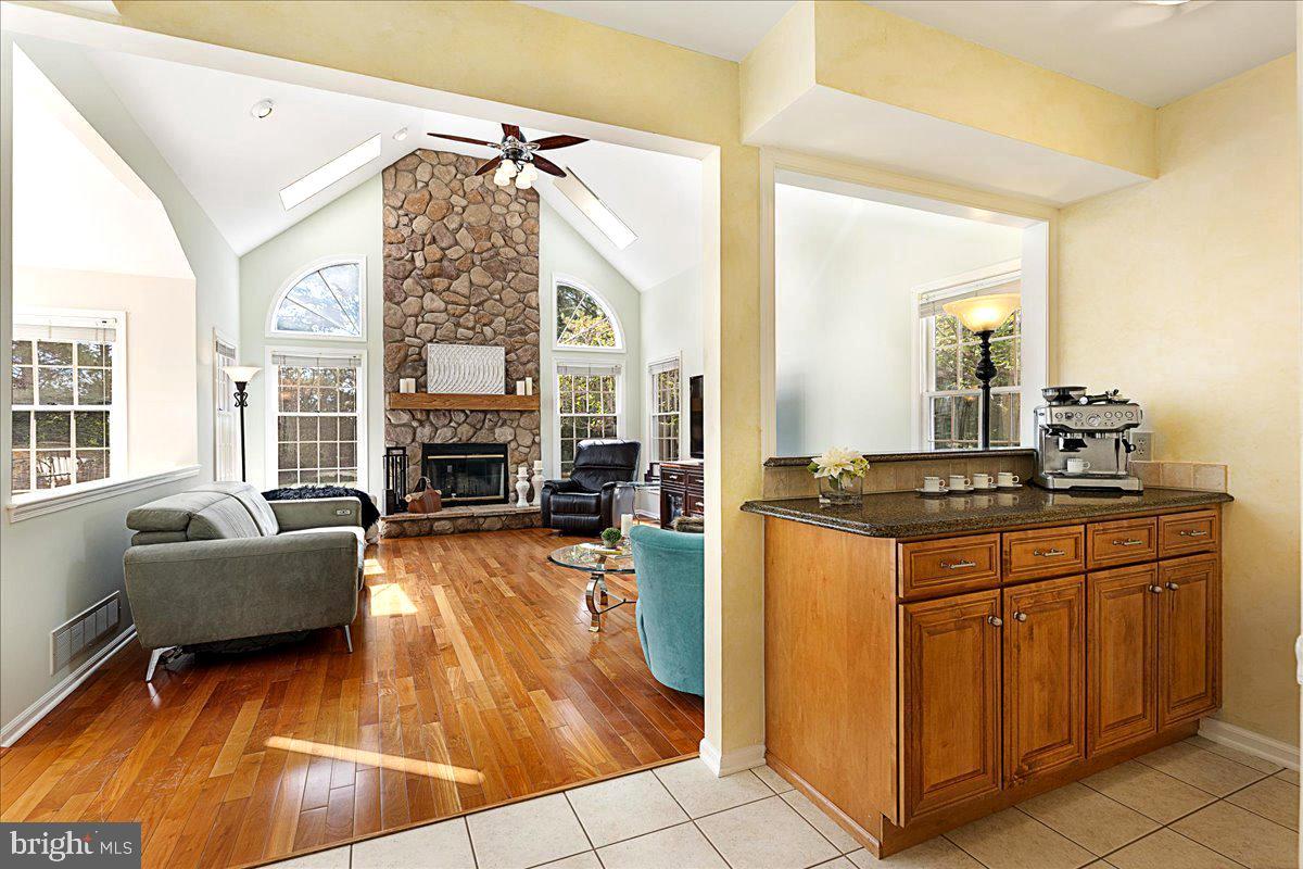 4 Banff Drive Princeton Junction, NJ 08550 - Photo 15 of 46 a living room with furniture a fireplace and a chandelier