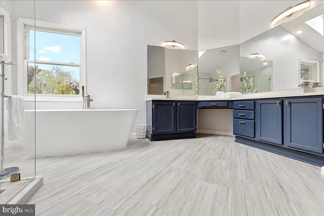 a large spacious bathroom with a large tub and sink