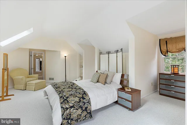 a living room with furniture a window and a flat screen tv