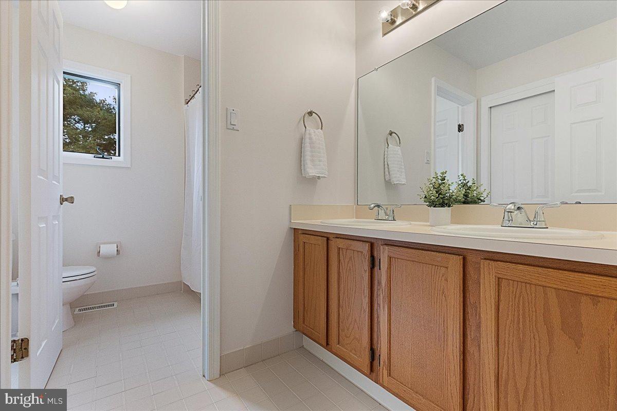 4 Banff Drive Princeton Junction, NJ 08550 - Photo 33 of 46 a bathroom with a double vanity sink toilet and a mirror