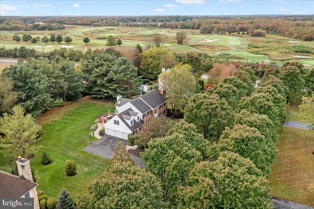 an aerial view of a house with pool water fountain and bench