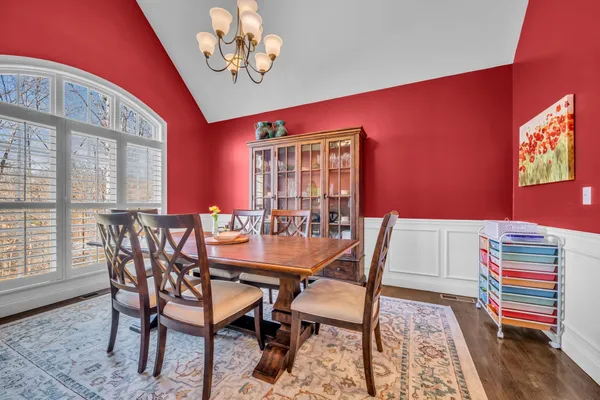 a view of a dining room with furniture and a window