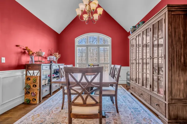 a large kitchen with stainless steel appliances granite countertop a lot of counter space and wooden floor