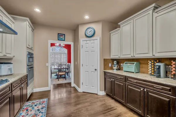 a kitchen with stainless steel appliances granite countertop a sink wooden cabinets and stainless steel appliances