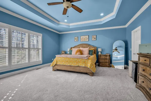 a bedroom with a bed and a chandelier