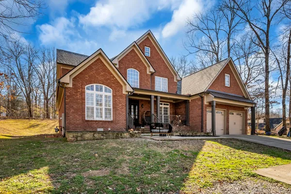 a front view of a house with yard swimming pool and outdoor seating