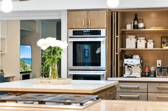 a view of living room kitchen with furniture and flat screen tv