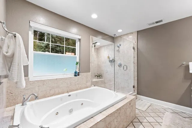 a bathroom with a bathtub and a shower