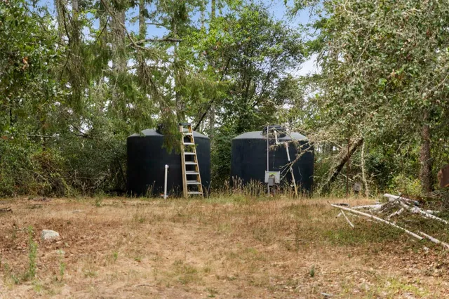 a backyard of a house with table and chairs